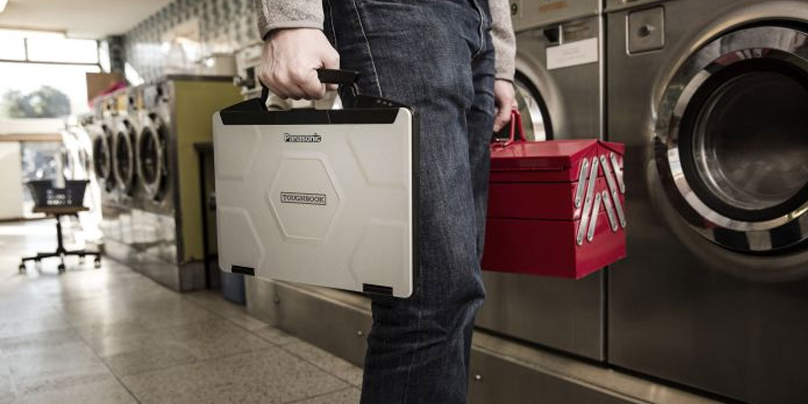 man carrying laptop
