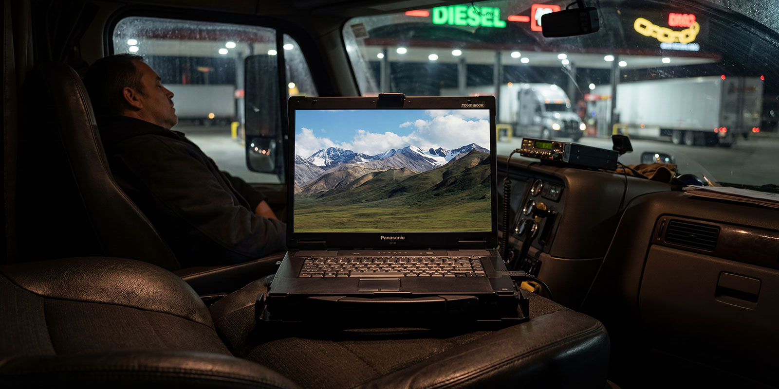 men sleeping in truck with laptop